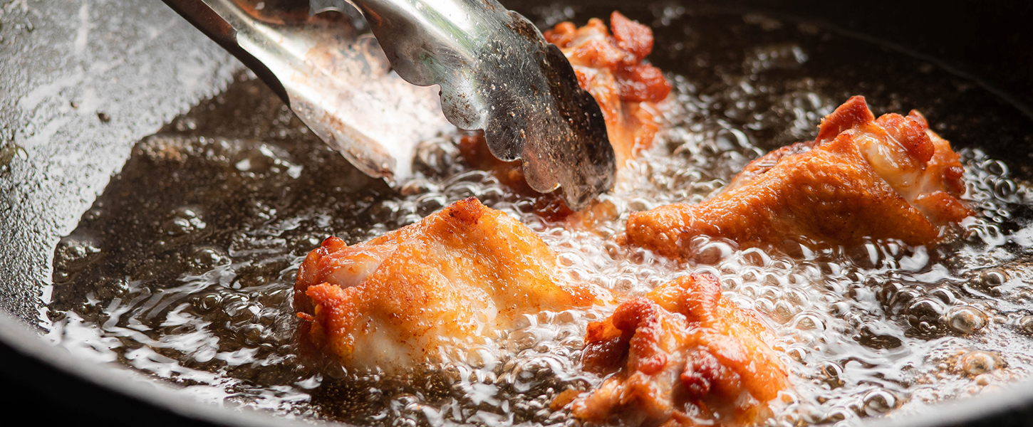 Close-up of chicken frying in a pan